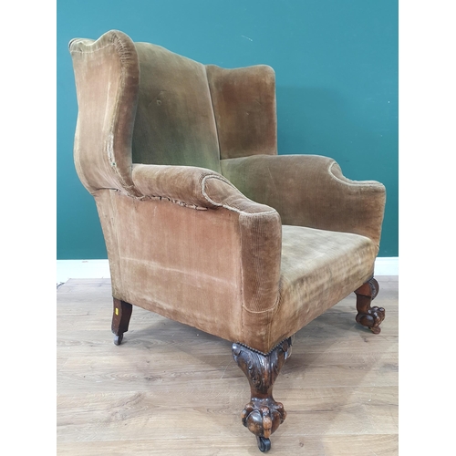 789 - A Georgian style Wing Back Armchair with green corduroy upholstery on leafage carved cabriole front ... 