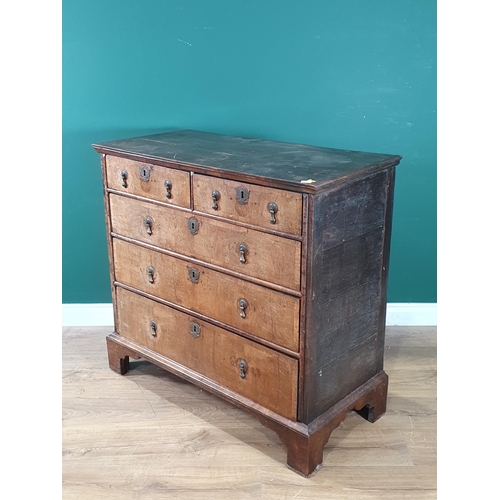 797 - An 18th Century oak and walnut veneered Chest of two short, three long graduated Drawers raised on b... 