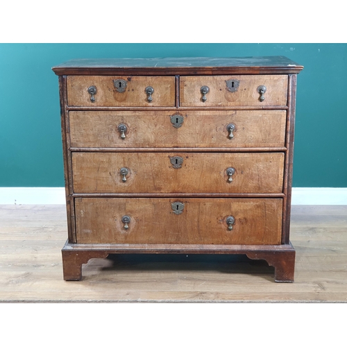 797 - An 18th Century oak and walnut veneered Chest of two short, three long graduated Drawers raised on b... 