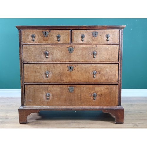 797 - An 18th Century oak and walnut veneered Chest of two short, three long graduated Drawers raised on b... 