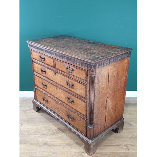 804 - A Georgian oak Chest of two short, three long graduated Drawers, with moulded cornice above floral f... 