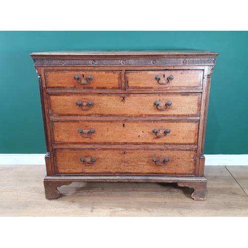 804 - A Georgian oak Chest of two short, three long graduated Drawers, with moulded cornice above floral f... 