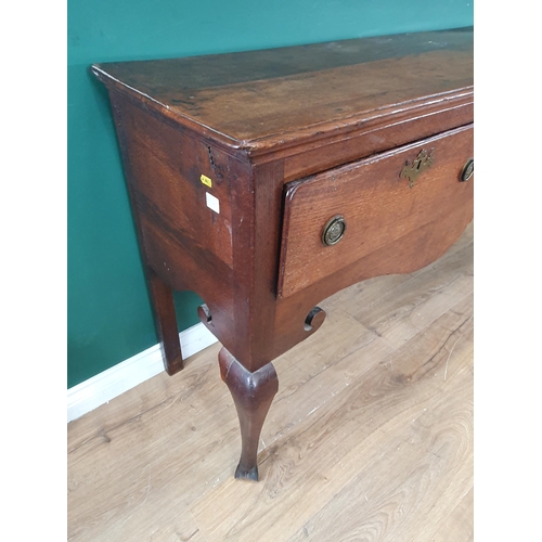 813 - An 18th Century oak Dresser Base with moulded top above three drawers and a shaped frieze on cabriol... 