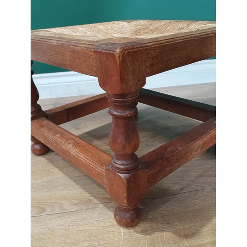 814 - A 20th Century pale oak square Stool with rush seat on stout baluster turned and square legs united ... 