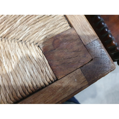 814 - A 20th Century pale oak square Stool with rush seat on stout baluster turned and square legs united ... 