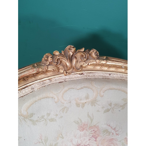 821 - A pair of French gilded open Elbow Chairs with cream floral needlework upholstery mounted upon cabri... 