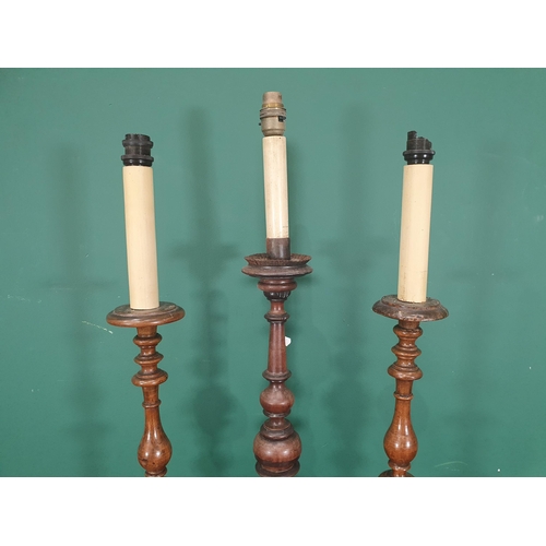 827 - A pair of walnut Table Lamps with baluster turned stems on circular bases, fitted electricity, and a... 