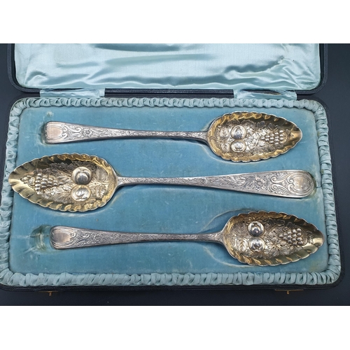 83 - A pair of George III silver Berry Spoons with fruit embossed bowls, London 1806, and another, simila... 