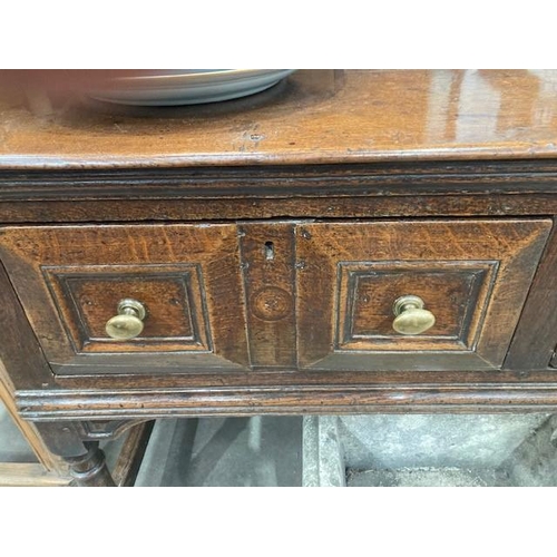 830 - A Charles II oak Dresser Base, fitted four moulded drawers on turned and squared supports and square... 