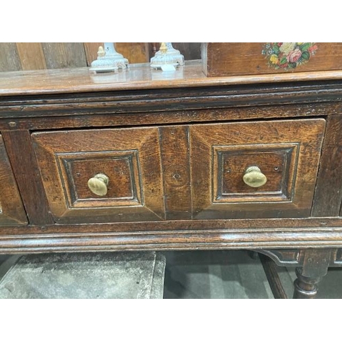 830 - A Charles II oak Dresser Base, fitted four moulded drawers on turned and squared supports and square... 