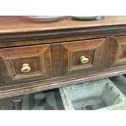 830 - A Charles II oak Dresser Base, fitted four moulded drawers on turned and squared supports and square... 