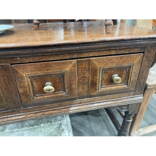 830 - A Charles II oak Dresser Base, fitted four moulded drawers on turned and squared supports and square... 