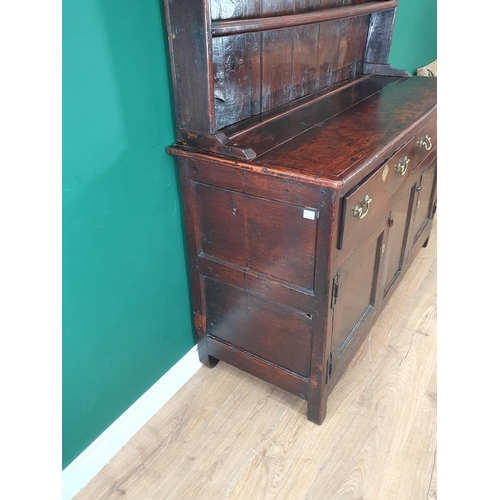 831 - An antique oak Dresser and Rack with enclosed shelves, the base fitted two drawers and two doors on ... 