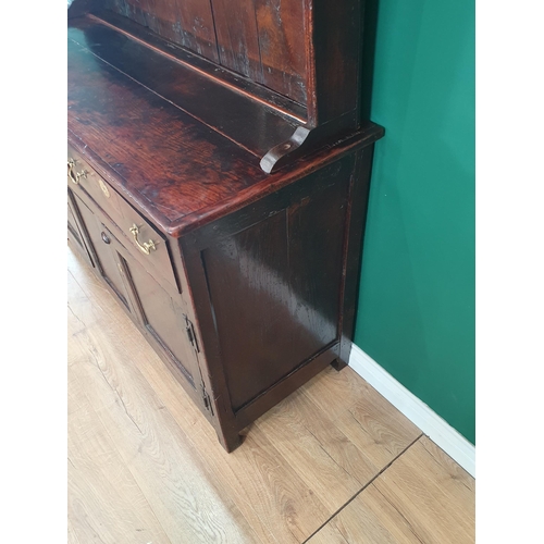 831 - An antique oak Dresser and Rack with enclosed shelves, the base fitted two drawers and two doors on ... 