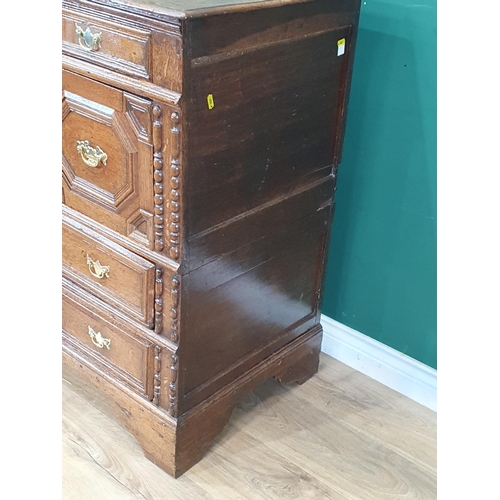 838 - An 18th Century oak Chest of four long drawers with moulded top above moulded drawer fronts on brack... 