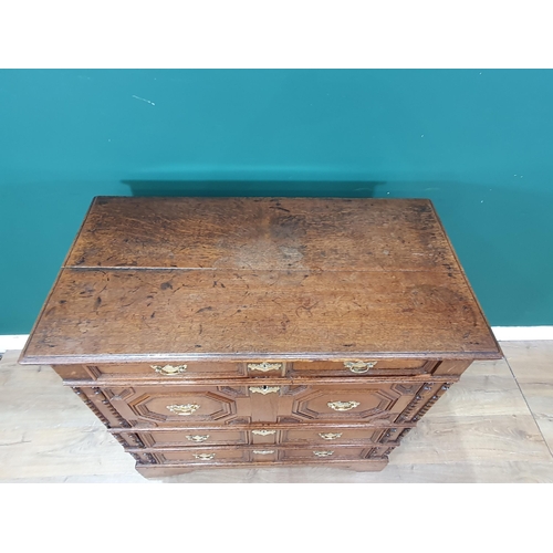 838 - An 18th Century oak Chest of four long drawers with moulded top above moulded drawer fronts on brack... 