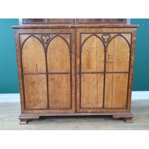 844 - A Gothic oak Bookcase with moulded cornice above a pair of astragal glazed doors enclosing adjustabl... 