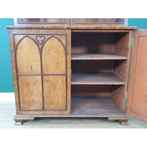 844 - A Gothic oak Bookcase with moulded cornice above a pair of astragal glazed doors enclosing adjustabl... 