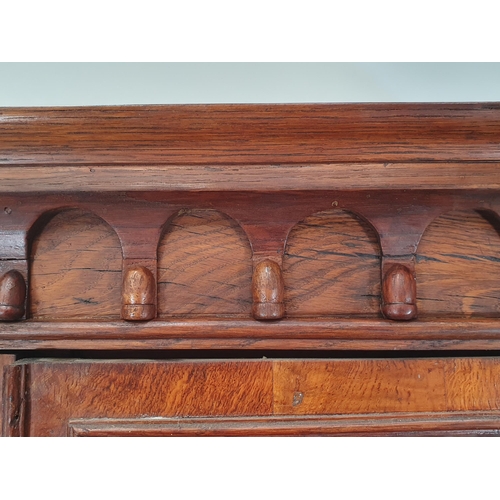 844 - A Gothic oak Bookcase with moulded cornice above a pair of astragal glazed doors enclosing adjustabl... 