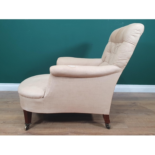 850 - A Howard and Sons deep seated button back upholstered Armchair, with square tapered front supports a... 