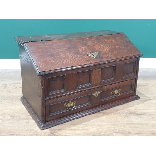 852 - An 18th Century oak slope fronted Desk Box, the hinged lid enclosing two pigeon holes above four pan... 