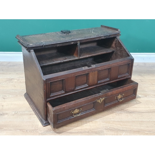 852 - An 18th Century oak slope fronted Desk Box, the hinged lid enclosing two pigeon holes above four pan... 