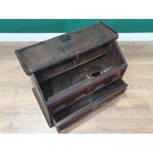 852 - An 18th Century oak slope fronted Desk Box, the hinged lid enclosing two pigeon holes above four pan... 