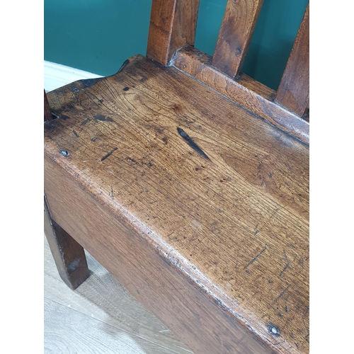 858 - An 18th Century Welsh elm and oak child's Bench with lath back and plank seat raised on squared supp... 