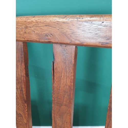 858 - An 18th Century Welsh elm and oak child's Bench with lath back and plank seat raised on squared supp... 