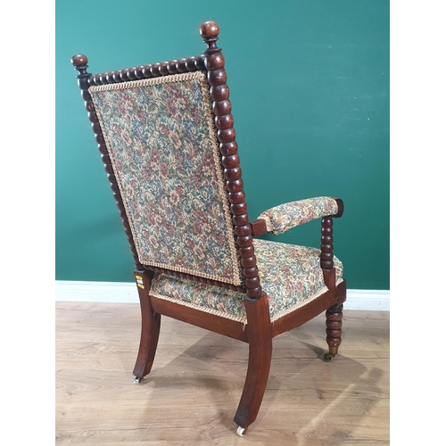 860 - A 19th Century bobbin turned Armchair with upholstered back and seat and raised bobbin turned front ... 