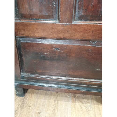 868 - An 18th Century oak Welsh Dresser and Rack, the enclosed shelves with moulded cornice, the base fitt... 