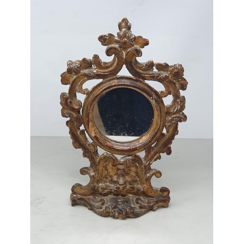 870 - An 18th Century carved and gilt Table Mirror with scroll and floral pierced surmount, with circular ... 