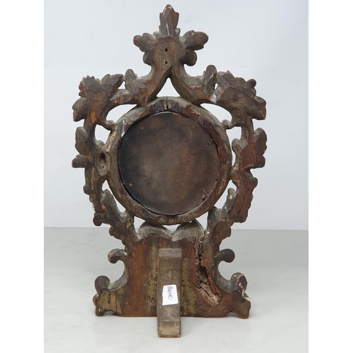 870 - An 18th Century carved and gilt Table Mirror with scroll and floral pierced surmount, with circular ... 