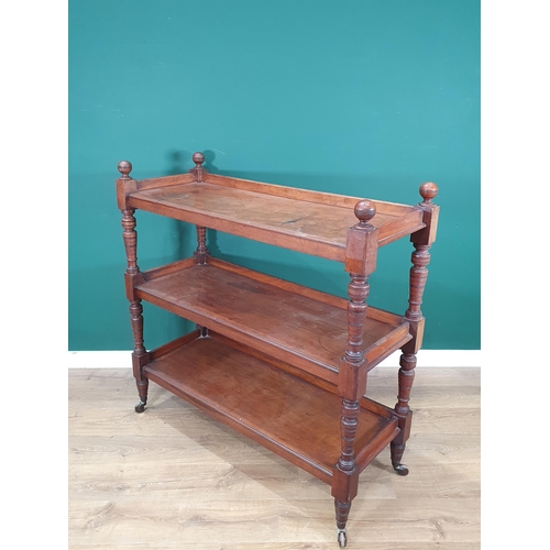 873 - A late 19th Century mahogany three tier Dumb Waiter with baluster turned supports and casters, 3ft 1... 