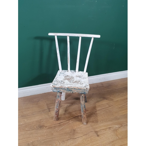 875 - A rustic white painted stick-back Child's Chair on four turned supports, 2ft 2in H (R2)