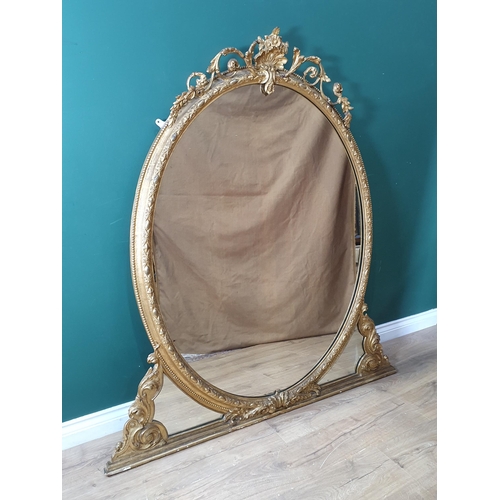 877 - A 19th Century gilt Overmantel Mirror, the shell and trailing leafage crest above an oval plate on s... 