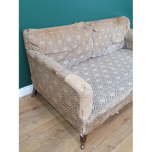 879 - A Howard and Sons two-seater Sofa with some 'H & S' monogrammed ticking, raised on square tapered fr... 