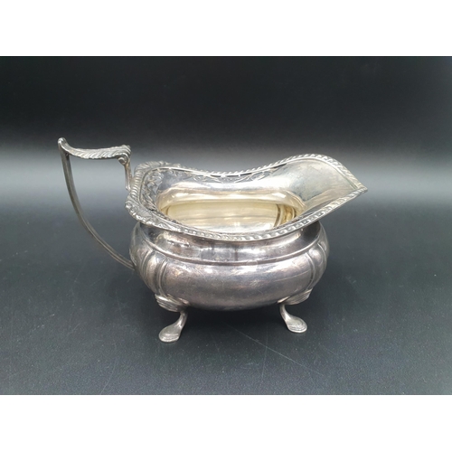 88 - A George V silver three piece Tea Service of boat shape with gadroon and pierced rims raised on shap... 