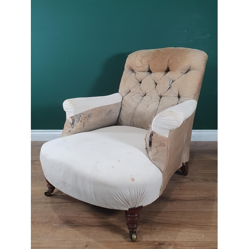 880 - A Howard and Sons deep seated button back Easy Chair, on turned front supports and castors, rear lef... 