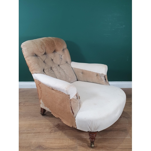 880 - A Howard and Sons deep seated button back Easy Chair, on turned front supports and castors, rear lef... 