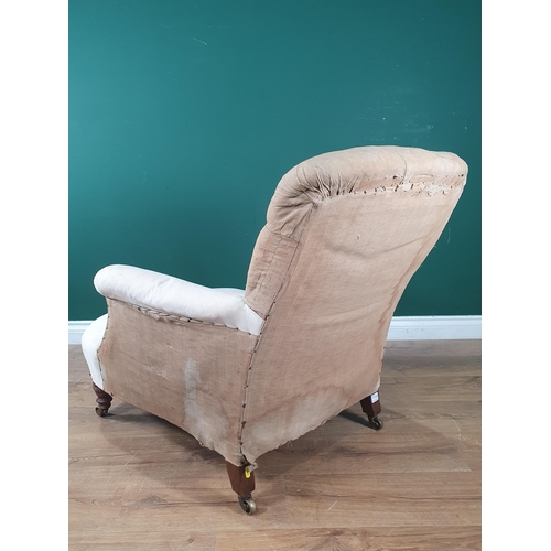 880 - A Howard and Sons deep seated button back Easy Chair, on turned front supports and castors, rear lef... 