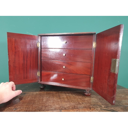 884 - A 19th Century mahogany Sewing Cabinet fitted a pair of cupboard doors enclosing a top drawer with c... 