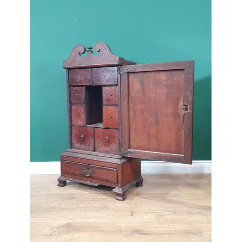 885 - An early 18th century oak Table Top Spice Cupboard, the broken pediment top above a single door encl... 