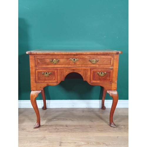 887 - An 18th Century walnut Lowboy with feather banded quarter veneered top, fitted three drawers around ... 