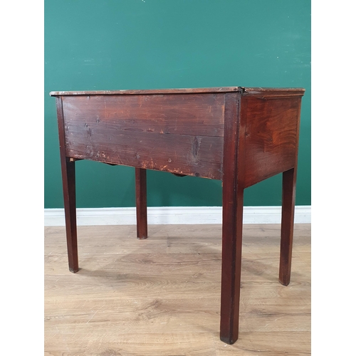 889 - A Georgian mahogany Lowboy fitted three drawers around a shaped frieze on chamfered squared supports... 