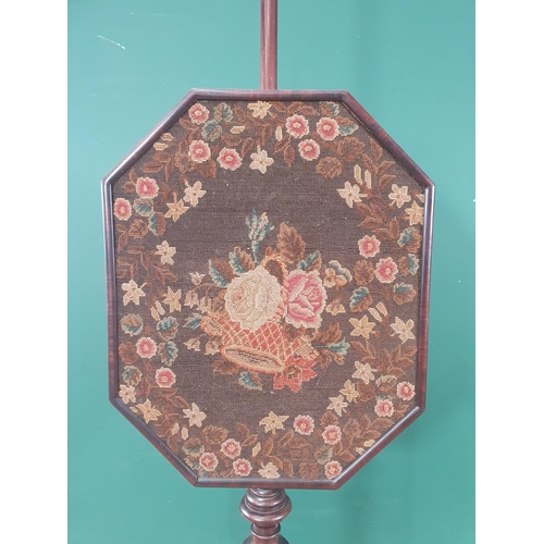 896 - A Regency mahogany Pole Screen, the octagonal adjustable woolwork screen above a shaped base on turn... 