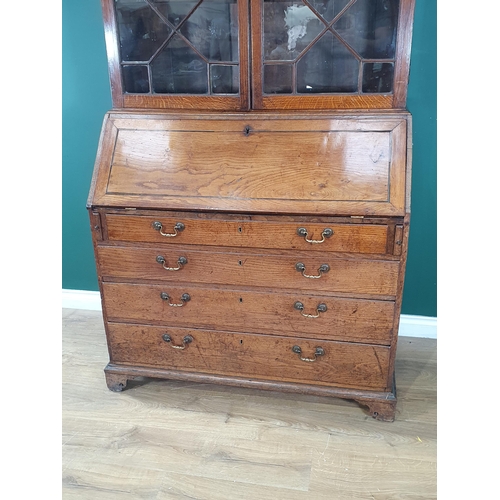 898 - An 18th Century oak Bureau Bookcase, the top with moulded cornice and inlaid scrollwork frieze above... 