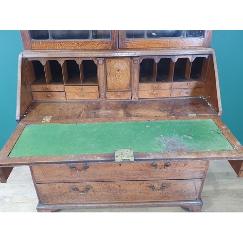 898 - An 18th Century oak Bureau Bookcase, the top with moulded cornice and inlaid scrollwork frieze above... 