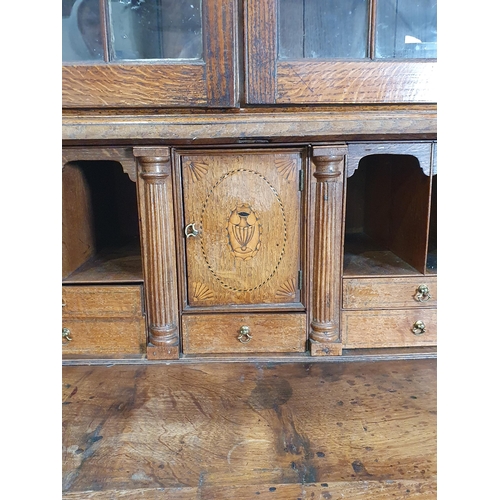 898 - An 18th Century oak Bureau Bookcase, the top with moulded cornice and inlaid scrollwork frieze above... 