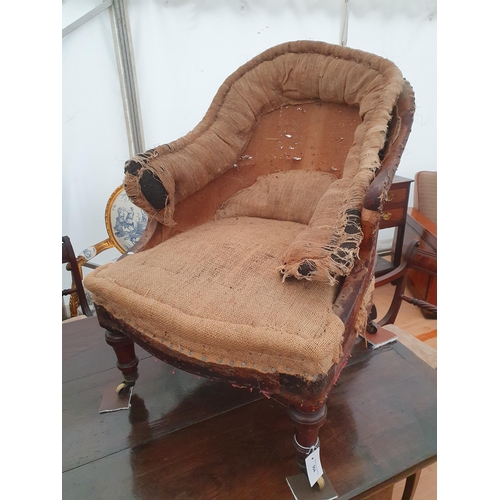 904 - A 19th Century Holland & Sons Armchair with turned front supports and casters, stamped to the back l... 